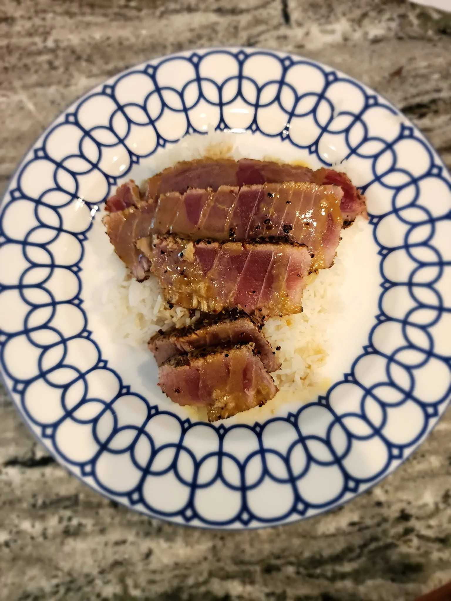 Seared ahi tuna with sesame crust sliced into medallions on a Blackstone griddle