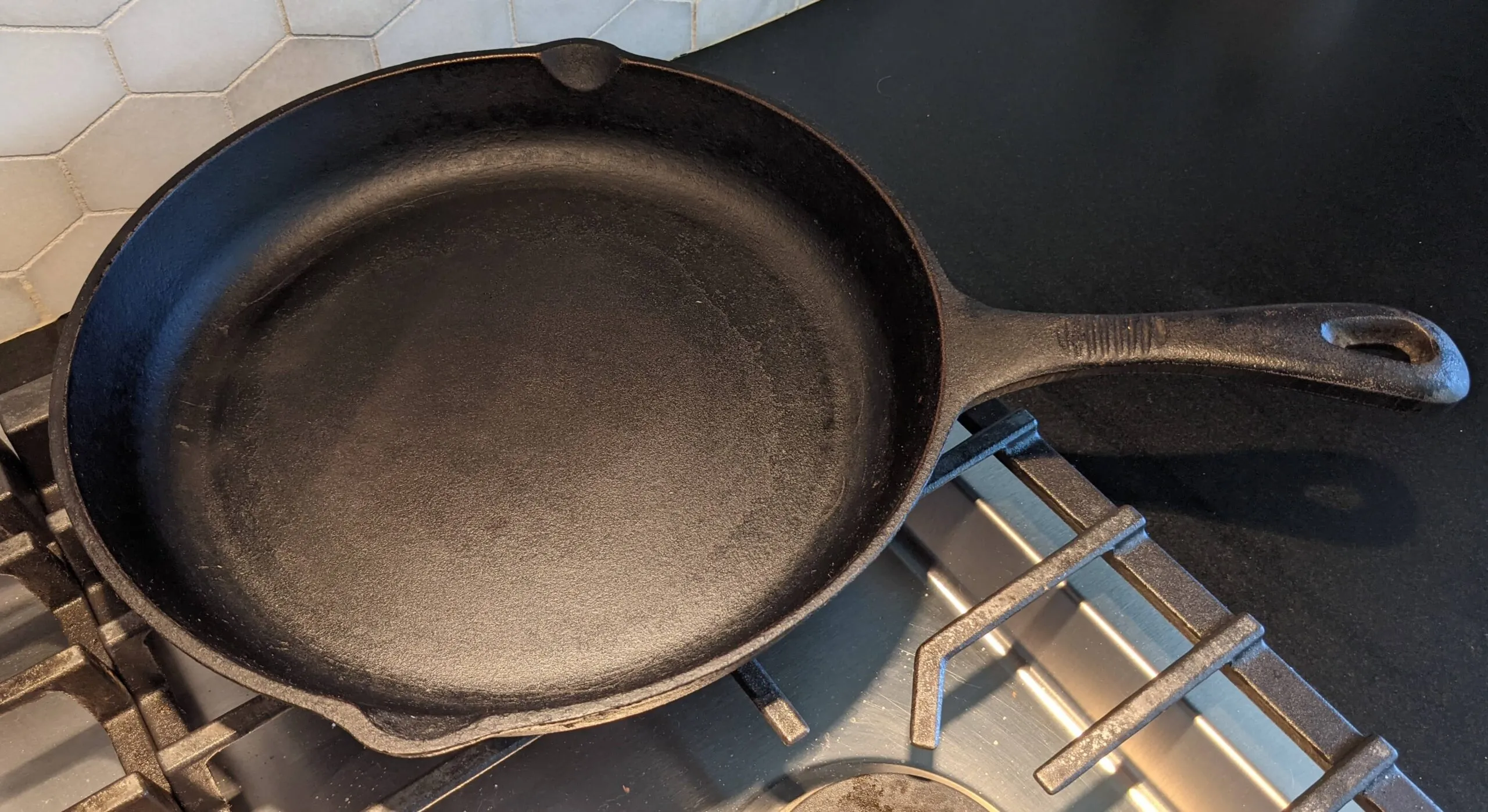 Well-seasoned cast iron skillet on a stovetop