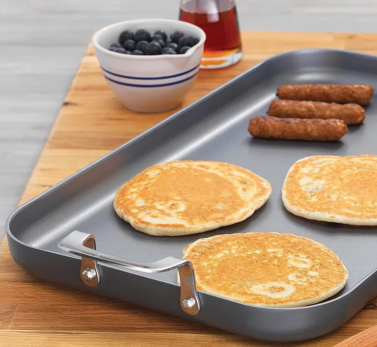 Cast iron griddle pan sitting on a glass top electric stove