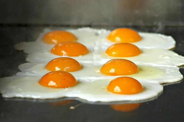 Eggs cooking on a Blackstone griddle