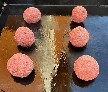Ground beef balls portioned for smash burgers