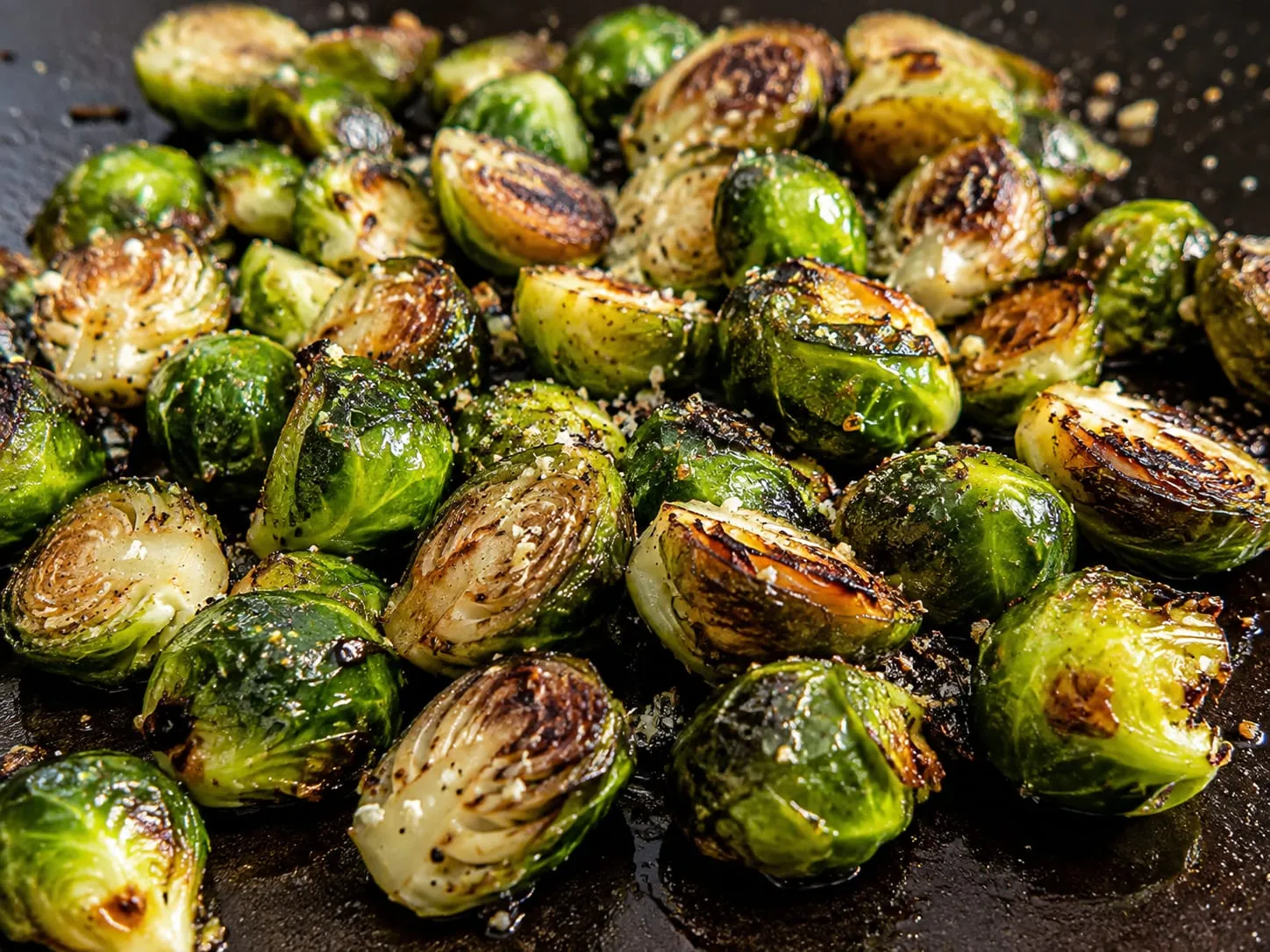 Charred and caramelized Brussels sprouts halves on a Blackstone griddle