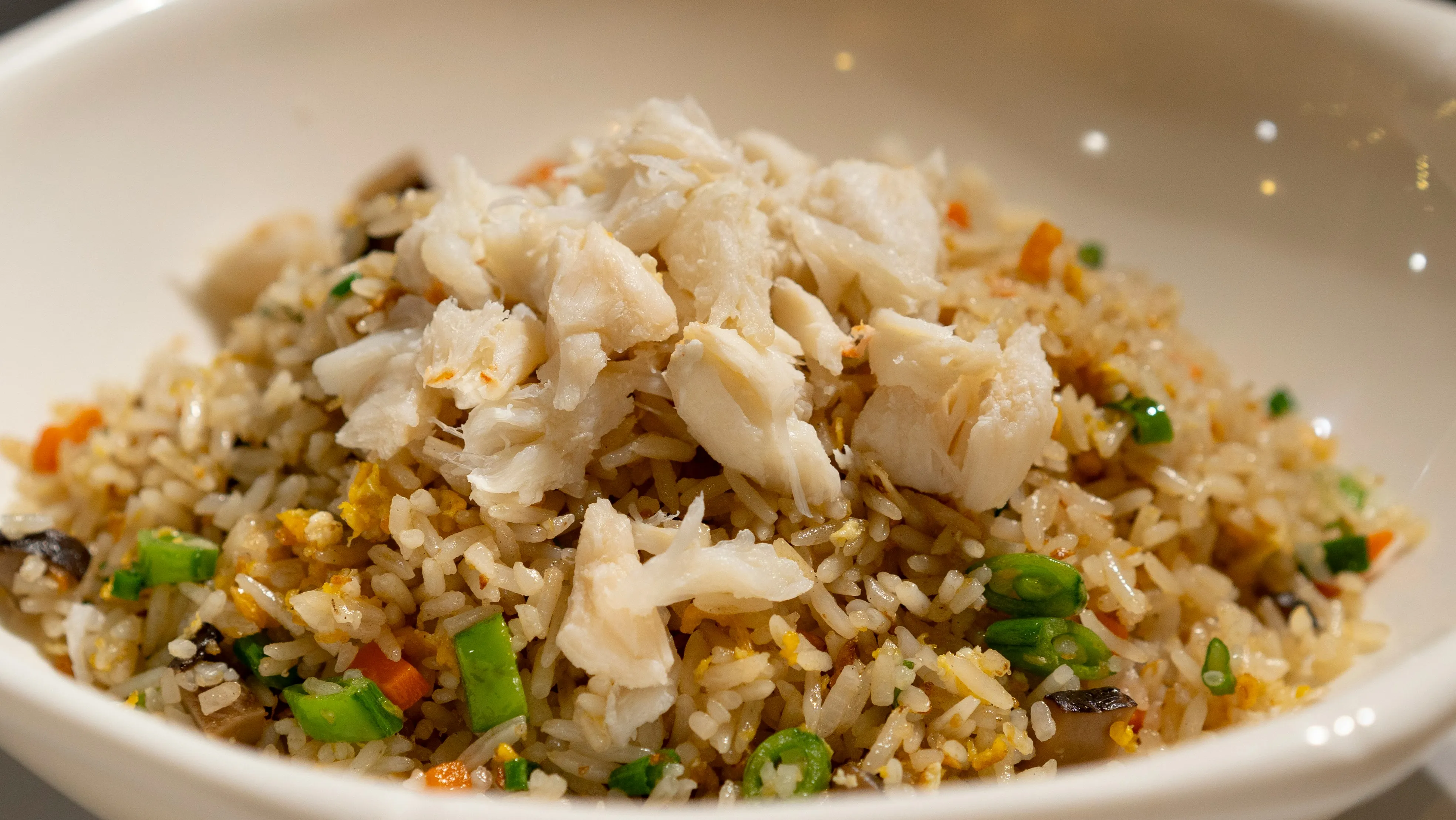 Blackstone chicken fried rice with scrambled egg and vegetables on the flat-top griddle