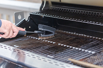 Cleaning a grill with brush