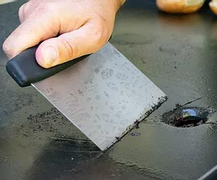 Cleaning a Blackstone Griddle with Griddle Scraper